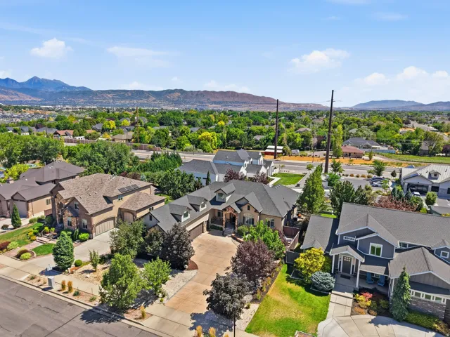 Expansive residential property featuring a multi-level design, attached garage, and mature landscaping