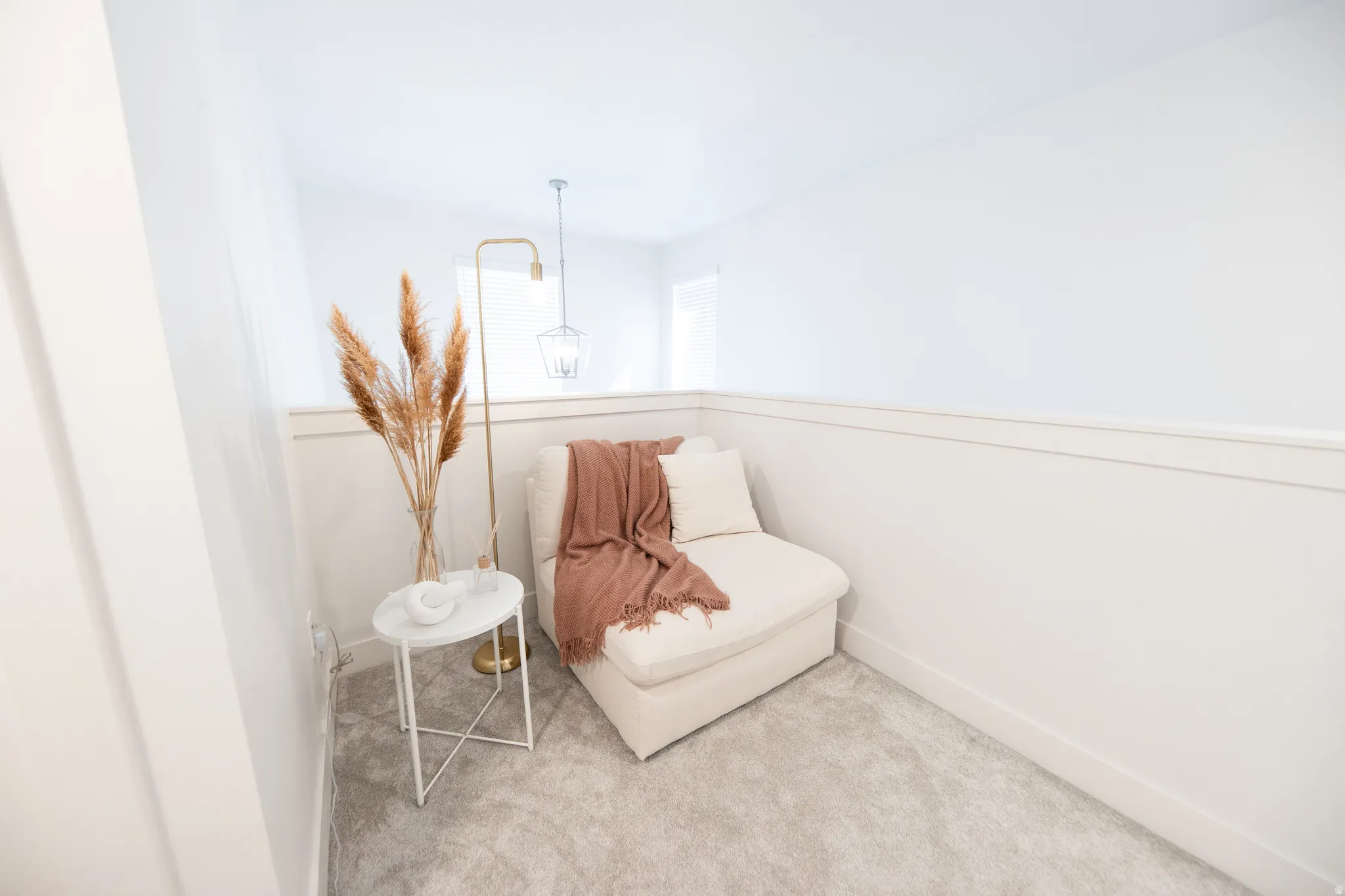 Carpeted alcove featuring white walls and trim, with a single window offering natural light