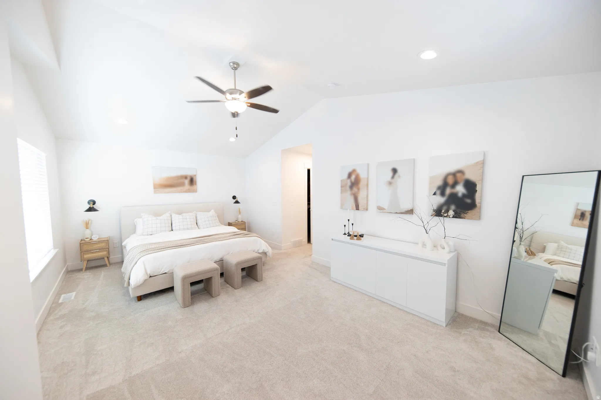 Spacious room featuring vaulted ceilings, recessed lighting, and light-toned carpeting