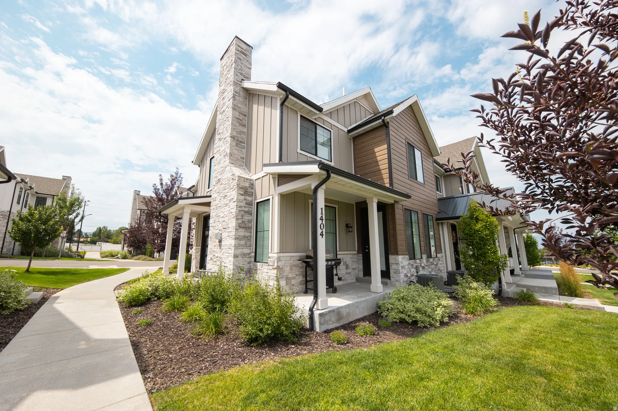 Modern townhome exterior featuring a stone and siding facade