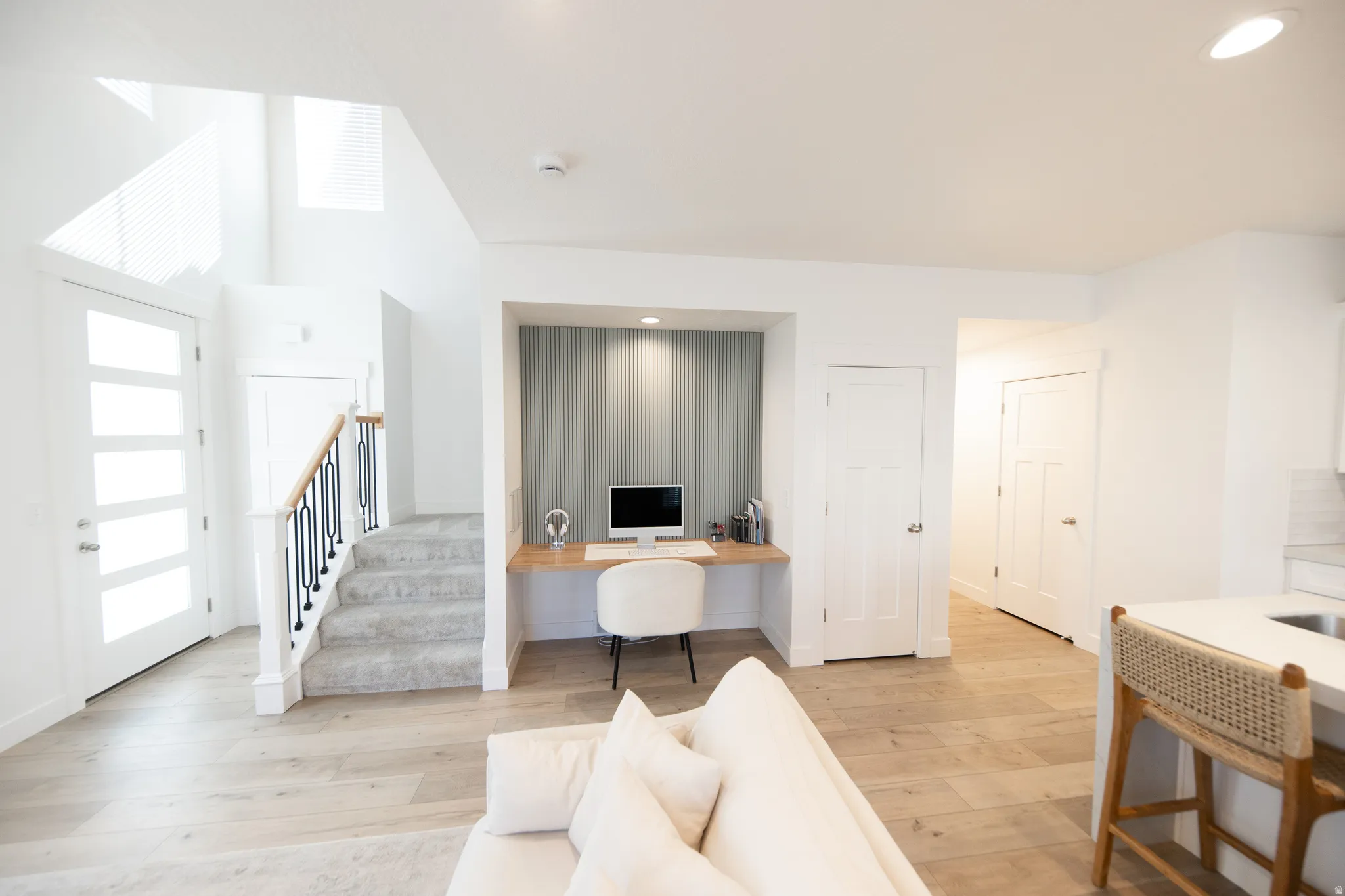 Integrated office nook featuring recessed lighting and vertical panel accent wall