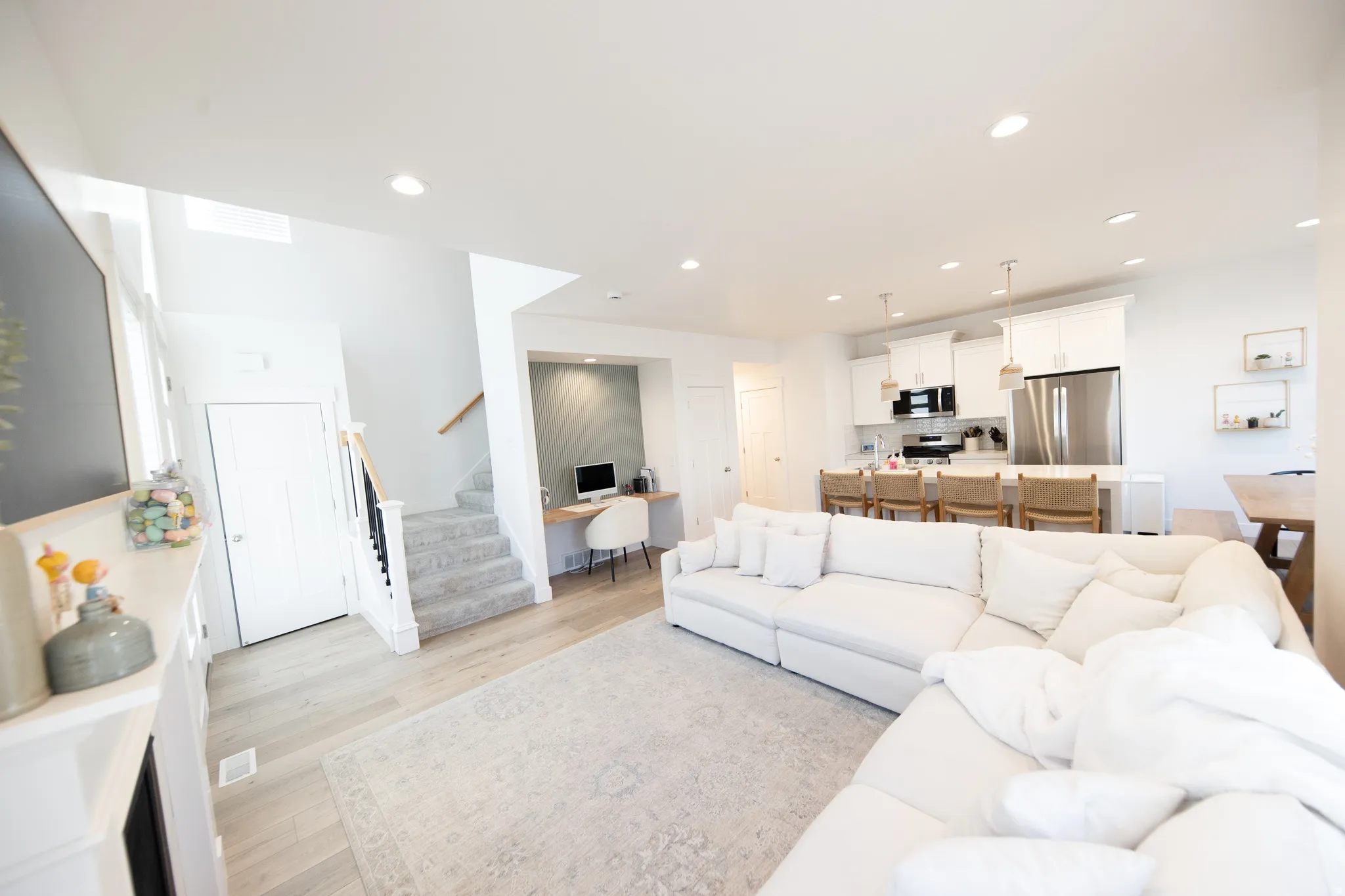 Open concept living space featuring wood-finish flooring and recessed lighting