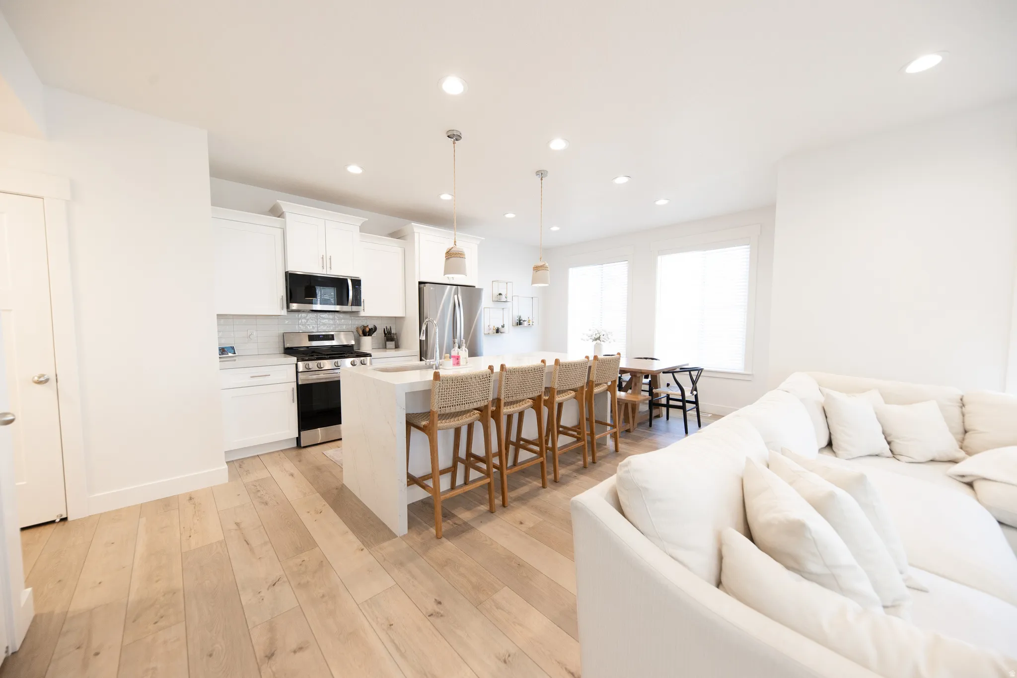 Open-concept living area featuring light wood-finish flooring