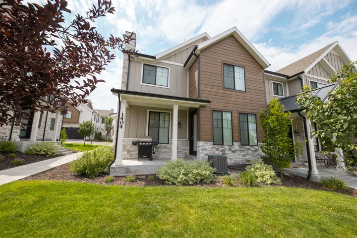 Contemporary exterior with varied siding, stone accents, and black-framed windows