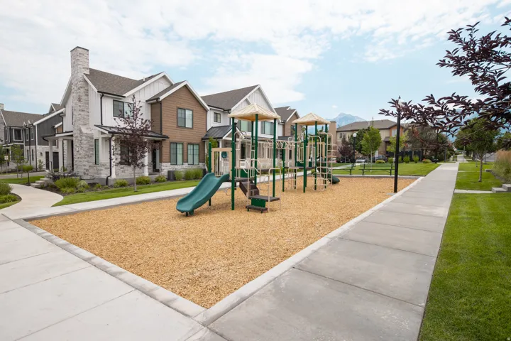 Community playground featuring multiple slides and climbing structures