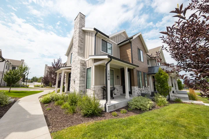 Modern townhome exterior featuring a stone and siding facade