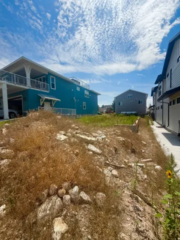 Vacant land parcel with partial retaining wall foundation