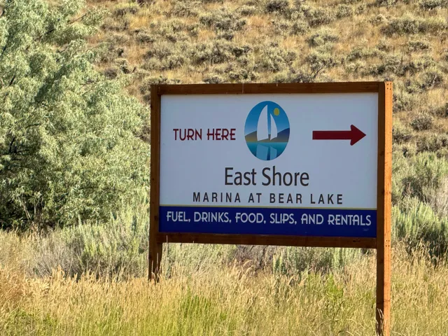 Marina signage featuring "East Shore Marina at Bear Lake" with directional arrow