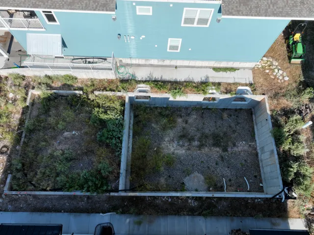 Excavated space featuring concrete retaining walls
