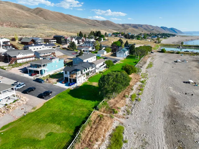 Coastal community featuring a variety of properties with mountainous terrain as a backdrop