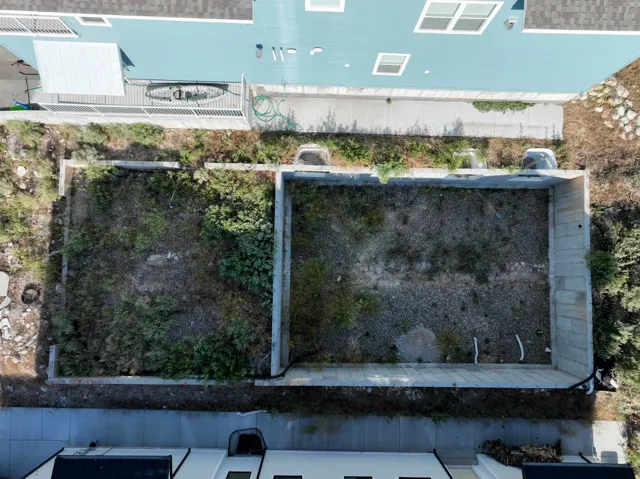Rear yard areas featuring concrete retaining walls