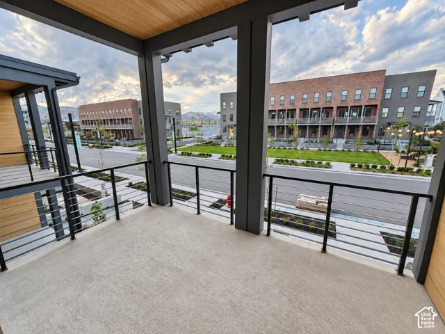 Private balcony with a wood-finish ceiling and concrete flooring
