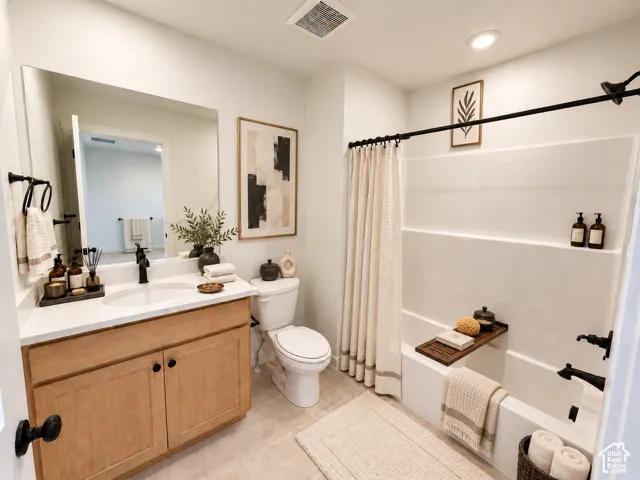 Vanity with a single basin sink, white countertop, and wood-finish cabinetry