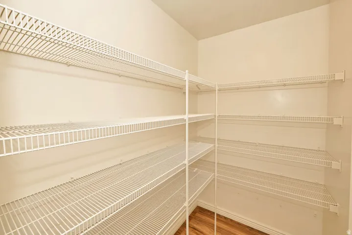 Spacious walk-in closet featuring white wire shelving throughout, providing multiple storage levels and organized storage solutions