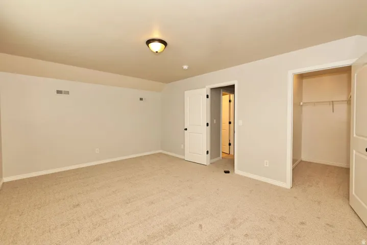 Carpeted room with light-toned walls and white trim