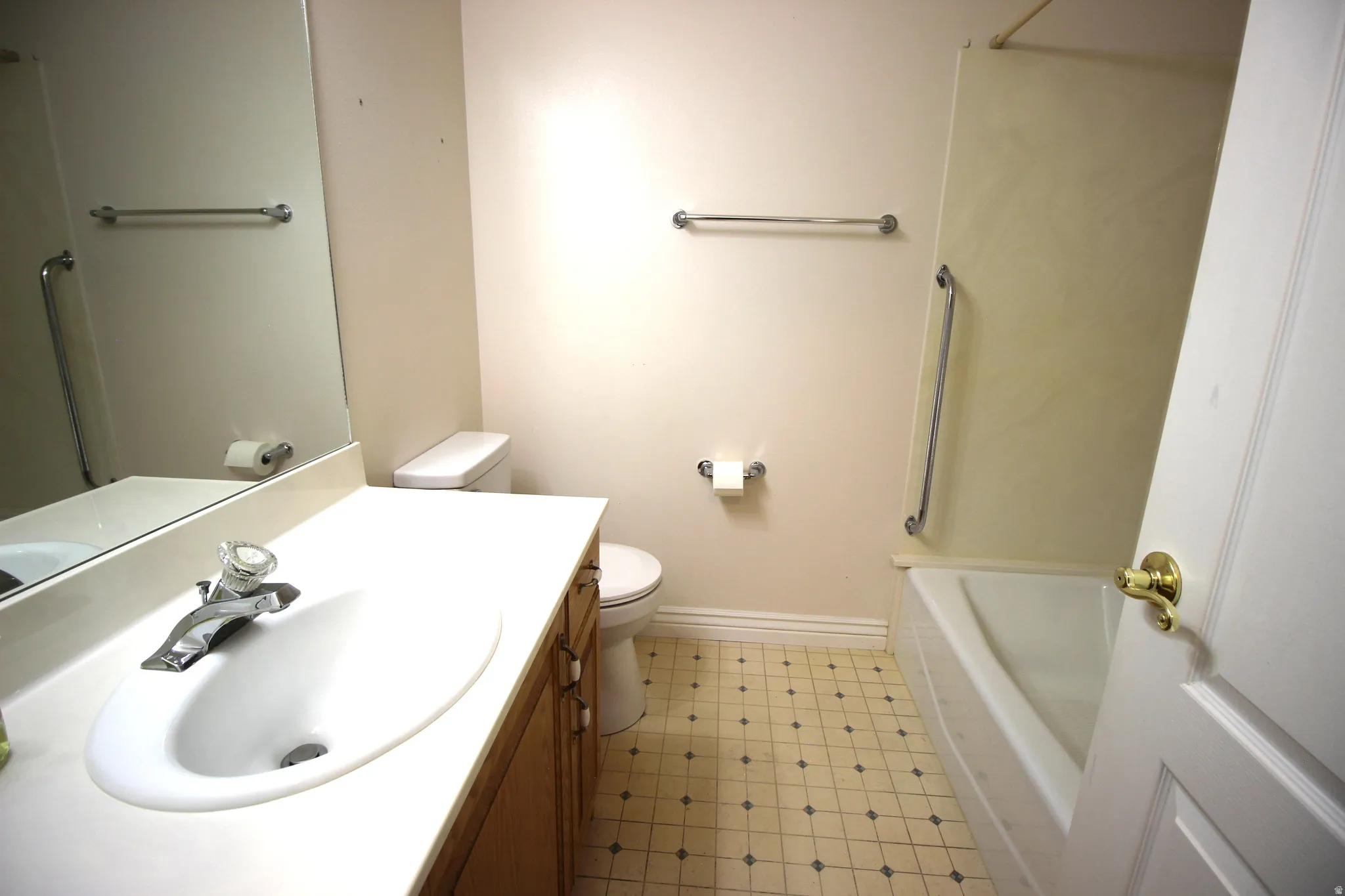 Vanity with an integrated sink, polished chrome faucet, and wood-finish cabinetry