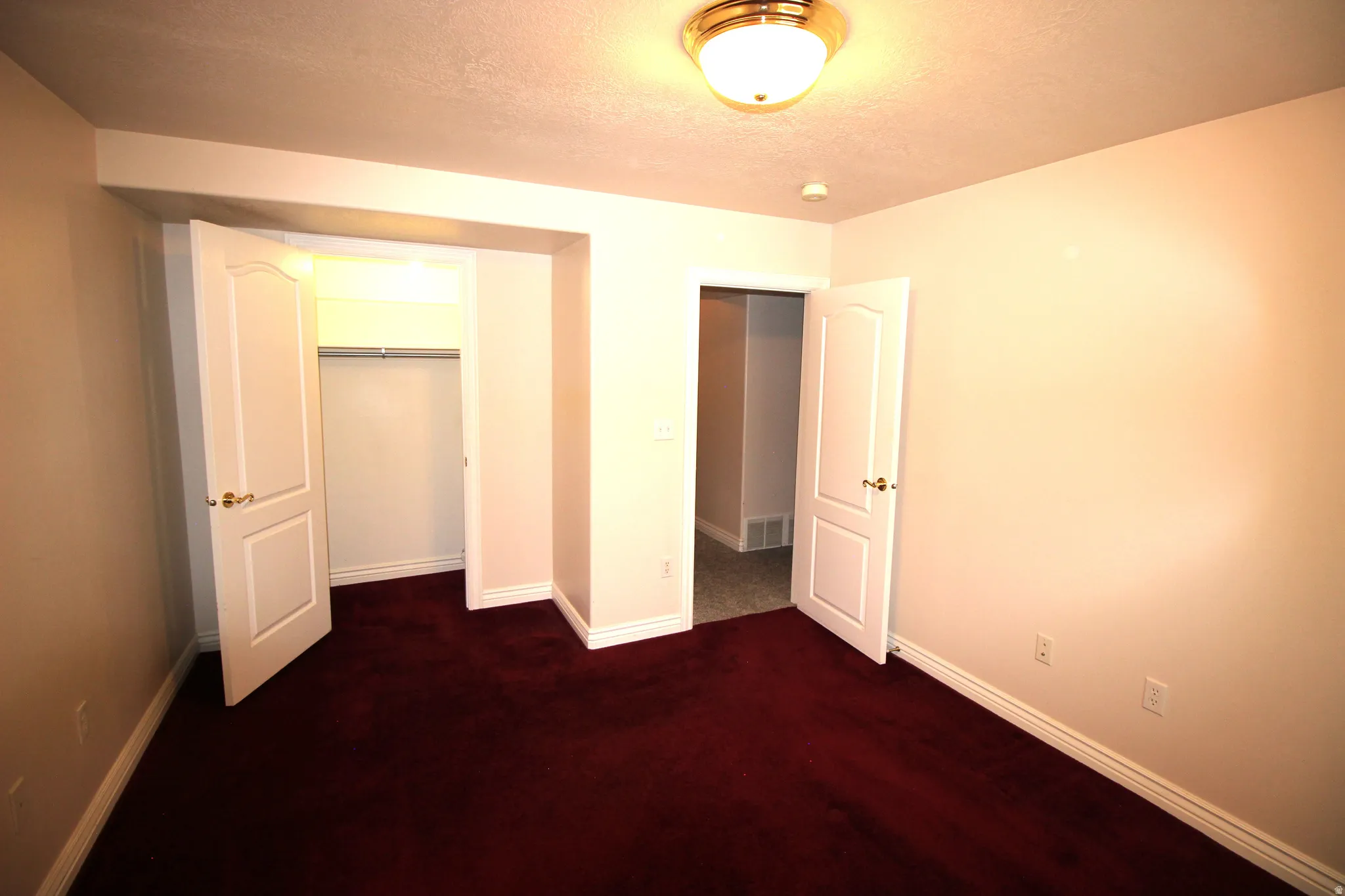 Red carpet flooring, white painted walls, white trim, recessed lighting, and a flush mount ceiling fixture