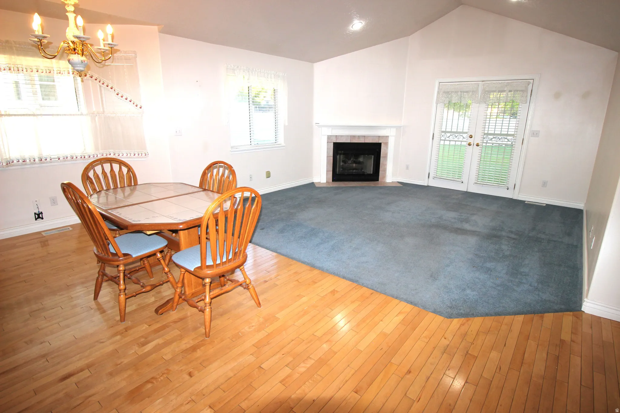 Big Family Room off Dining Area.  Vaulted ceiling, recessed lighting, fireplace with mantel, French doors, and wood-finish flooring