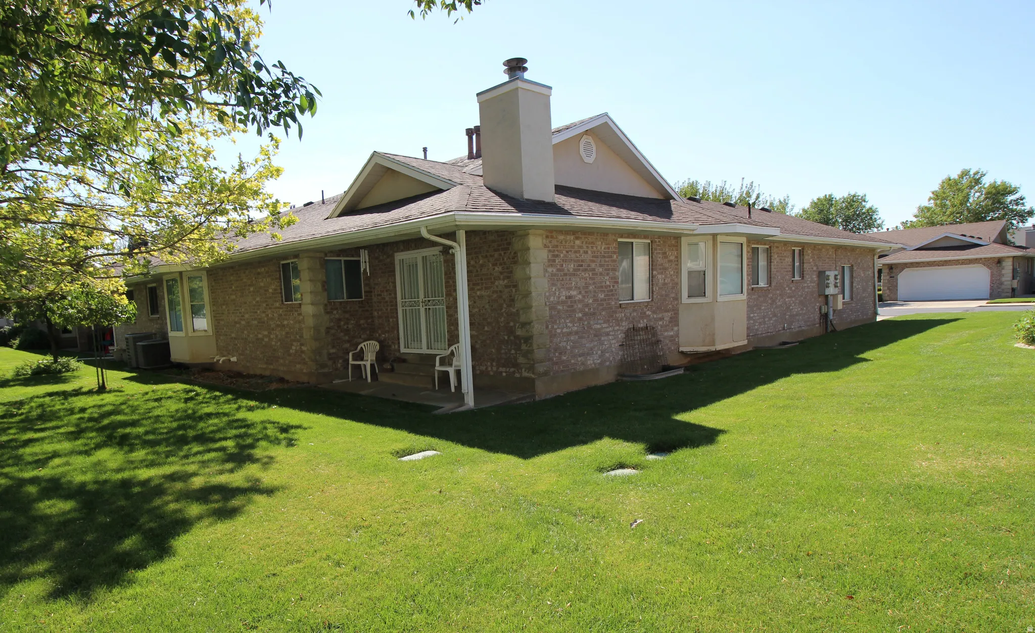 Brick exterior with a gabled roof and bay window