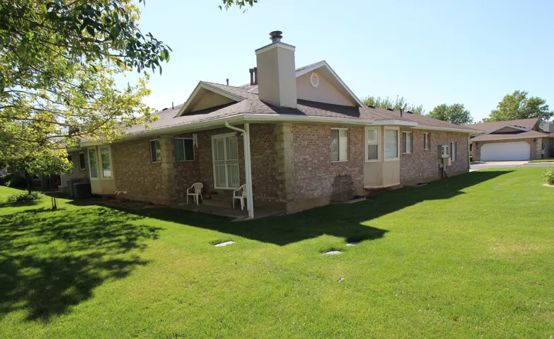 Brick exterior with a gabled roof and bay window