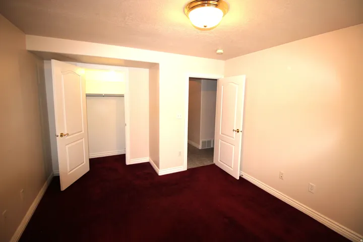 Red carpet flooring, white painted walls, white trim, recessed lighting, and a flush mount ceiling fixture