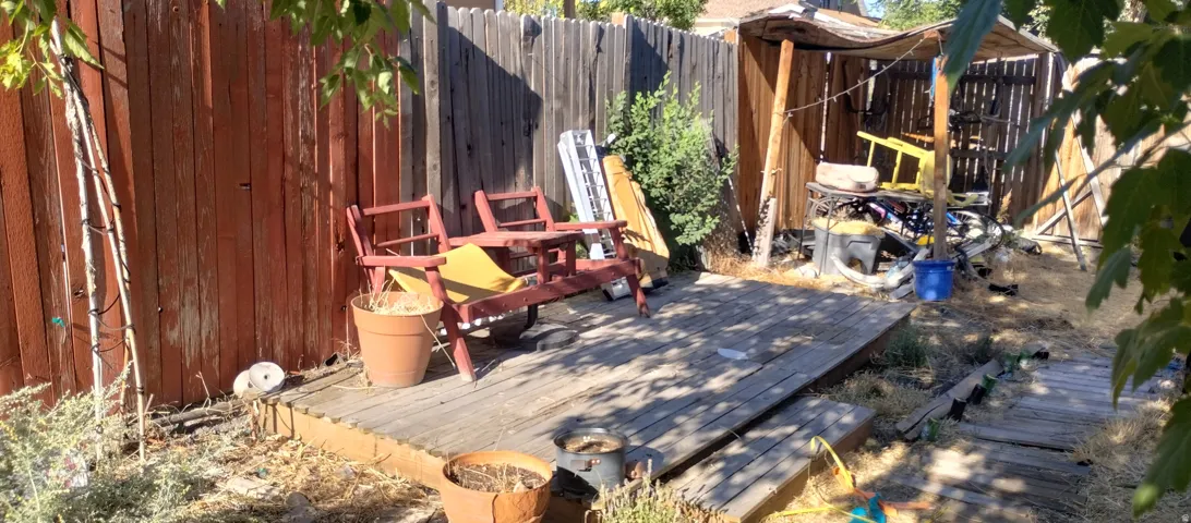 Wood deck area featuring a partial privacy fence