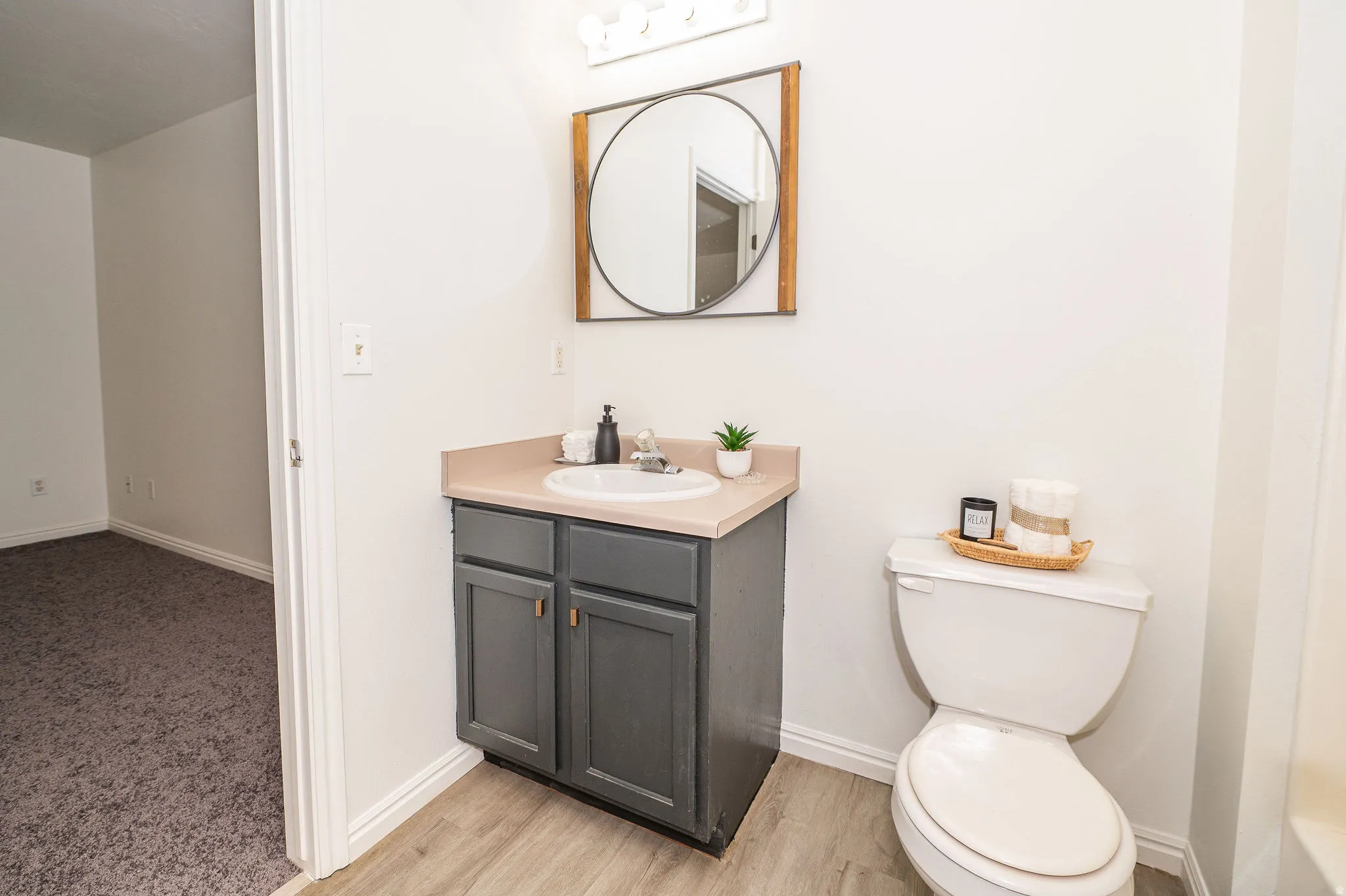 Full bathroom showing entry into large primary bedroom.