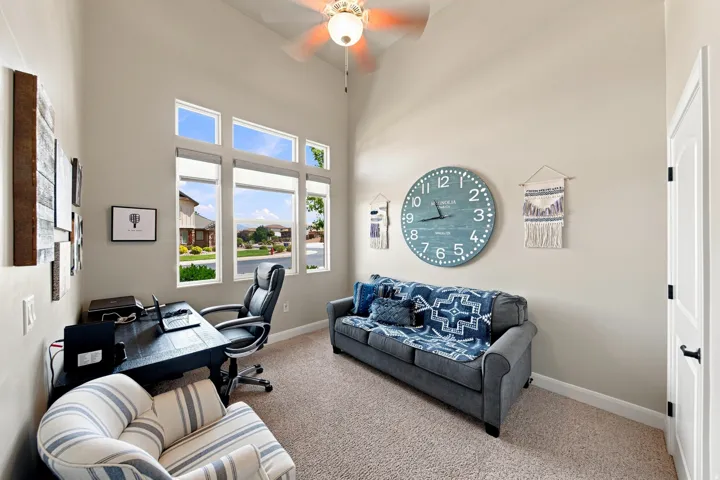 Versatile interior space featuring a vaulted ceiling and a ceiling fan
