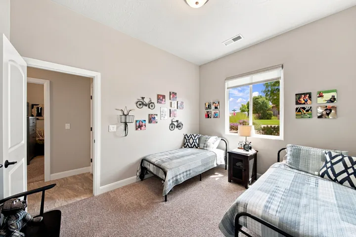 Carpeted room with neutral wall tones and a window offering natural light