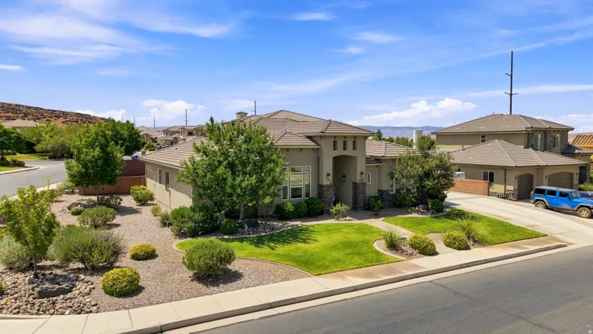 Contemporary stucco exterior with stone accents and a tiled roof