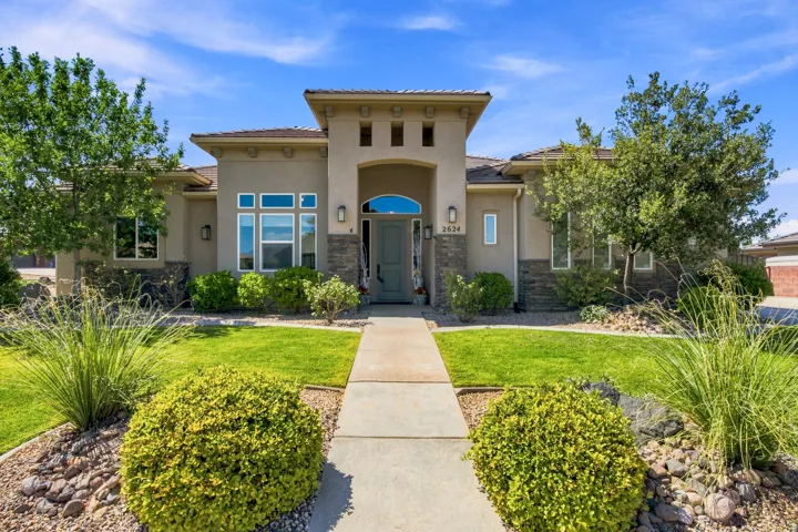 Stucco exterior with stone accents and a tile roof