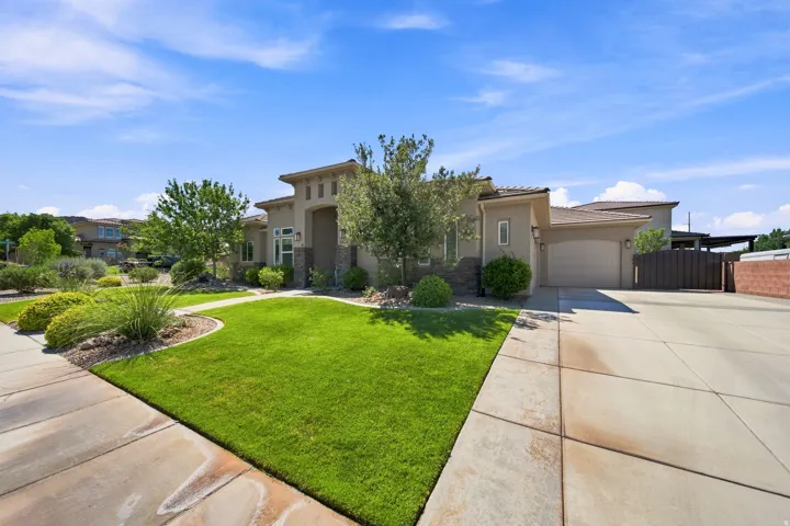 Stucco exterior with stone accents and a terracotta tile roof