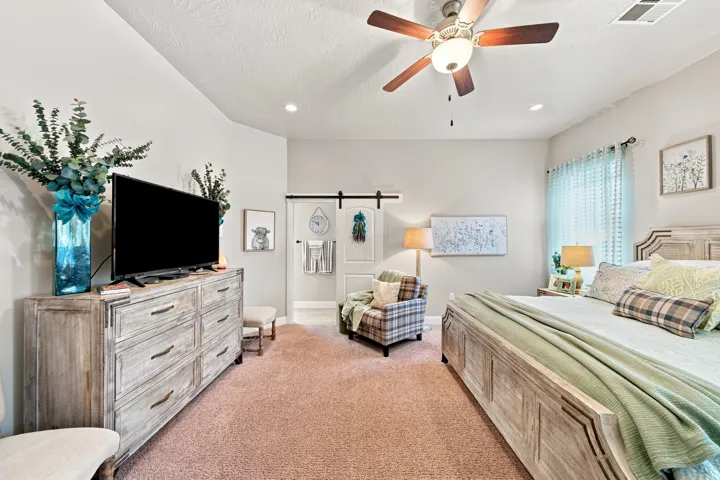 Spacious room featuring neutral wall tones, recessed lighting, and a ceiling fan