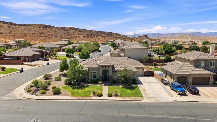 Spacious single-story residence with a tan stucco exterior and a three-car garage