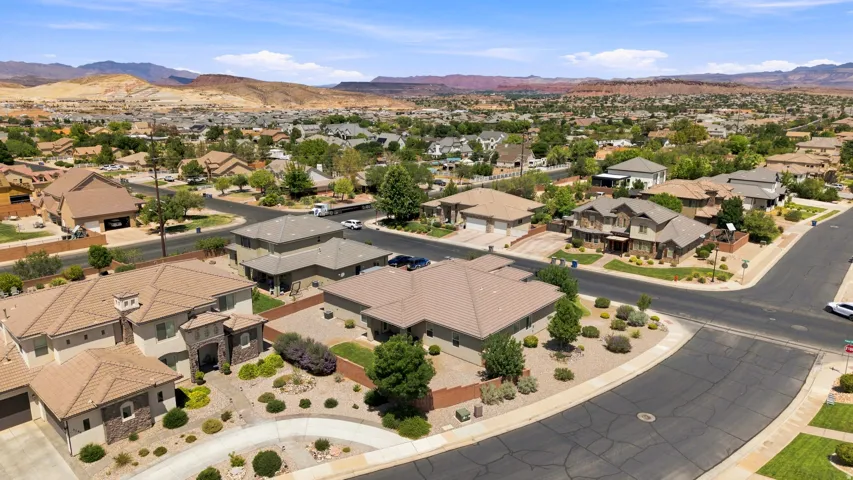 Residential neighborhood featuring a variety of single-family homes, paved streets, and arid landscaping