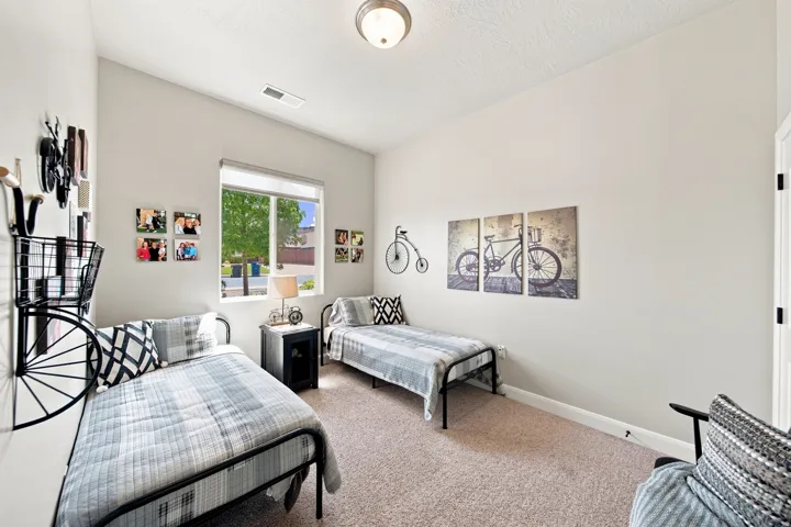 Spacious room featuring vaulted ceilings, a large window, neutral wall tones, and carpet flooring