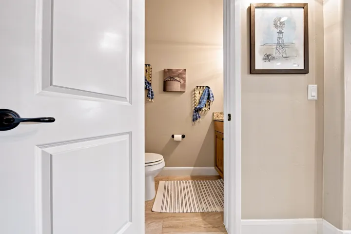 Bathroom featuring tile flooring, a white toilet, and a vanity with a countertop