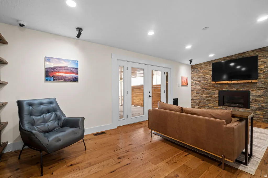 Living area featuring a stone accent wall with a built-in fireplace and media shelf