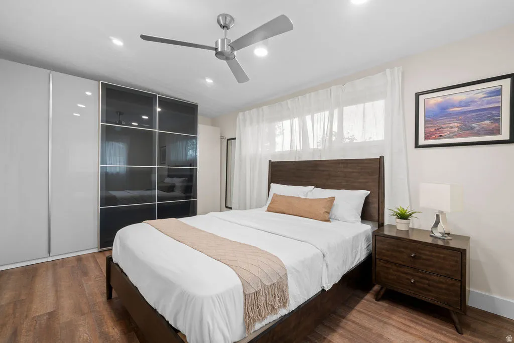Bedroom with wood-finish flooring, recessed lighting, and a ceiling fan