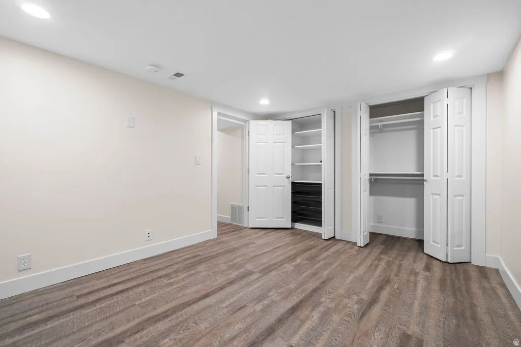 Open room featuring wood-finish flooring and recessed lighting