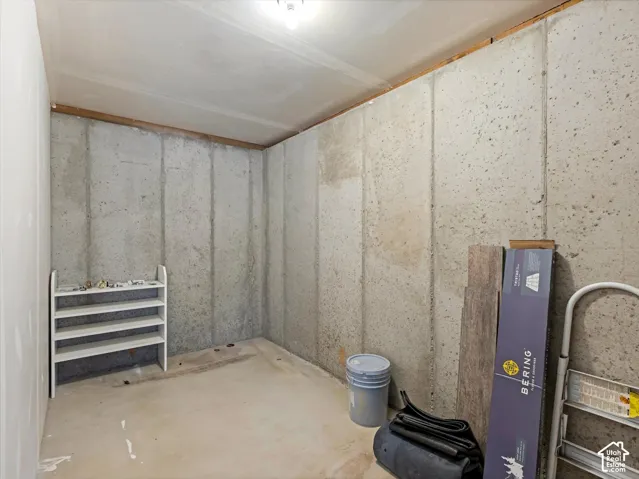 Unfinished room featuring concrete walls and concrete flooring