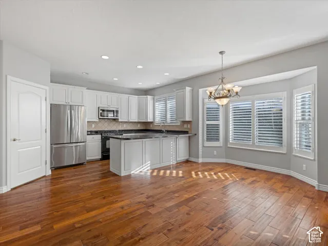 Open concept kitchen and dining area featuring wood-finish flooring