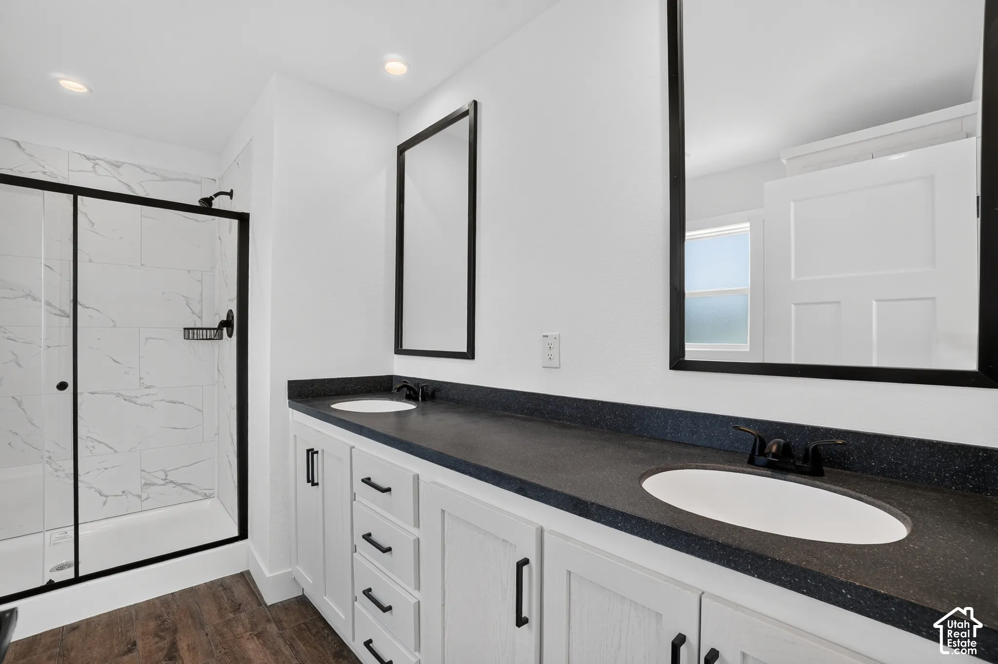 Dual vanity with dark speckled countertops and undermount sinks