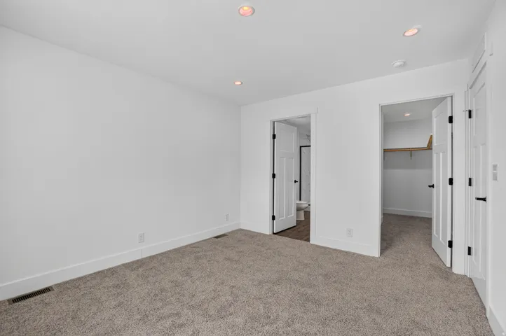 Neutral tone carpeting throughout the room