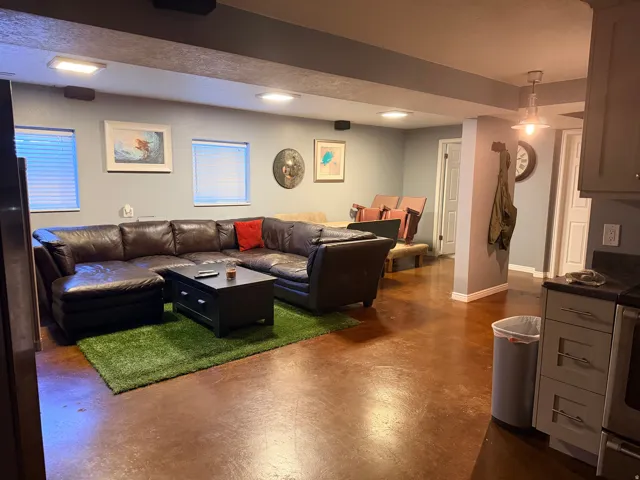 Spacious interior featuring brown-toned flooring, light gray walls, and recessed lighting