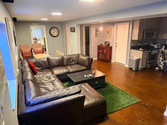 Open concept living area with durable concrete flooring