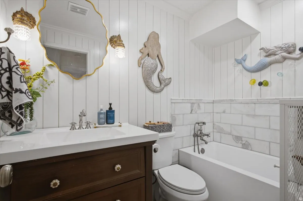 Bathroom featuring a dark wood vanity with a white countertop and integrated sink