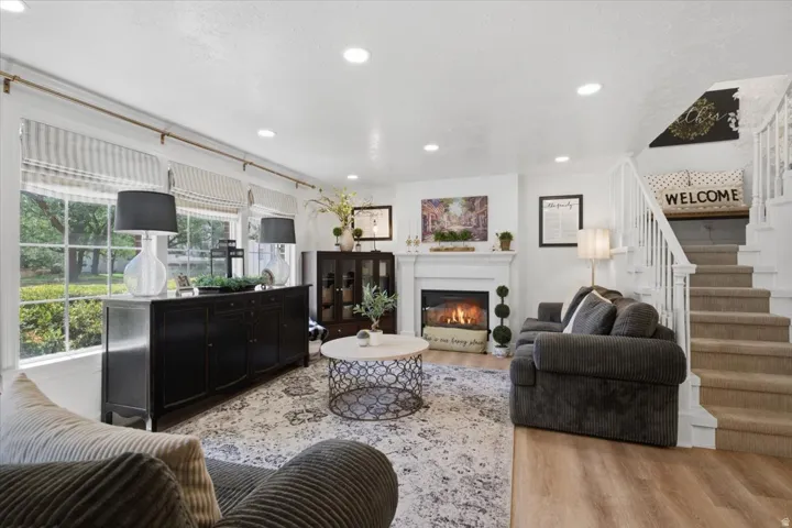 Living space featuring wood-finish flooring and recessed lighting