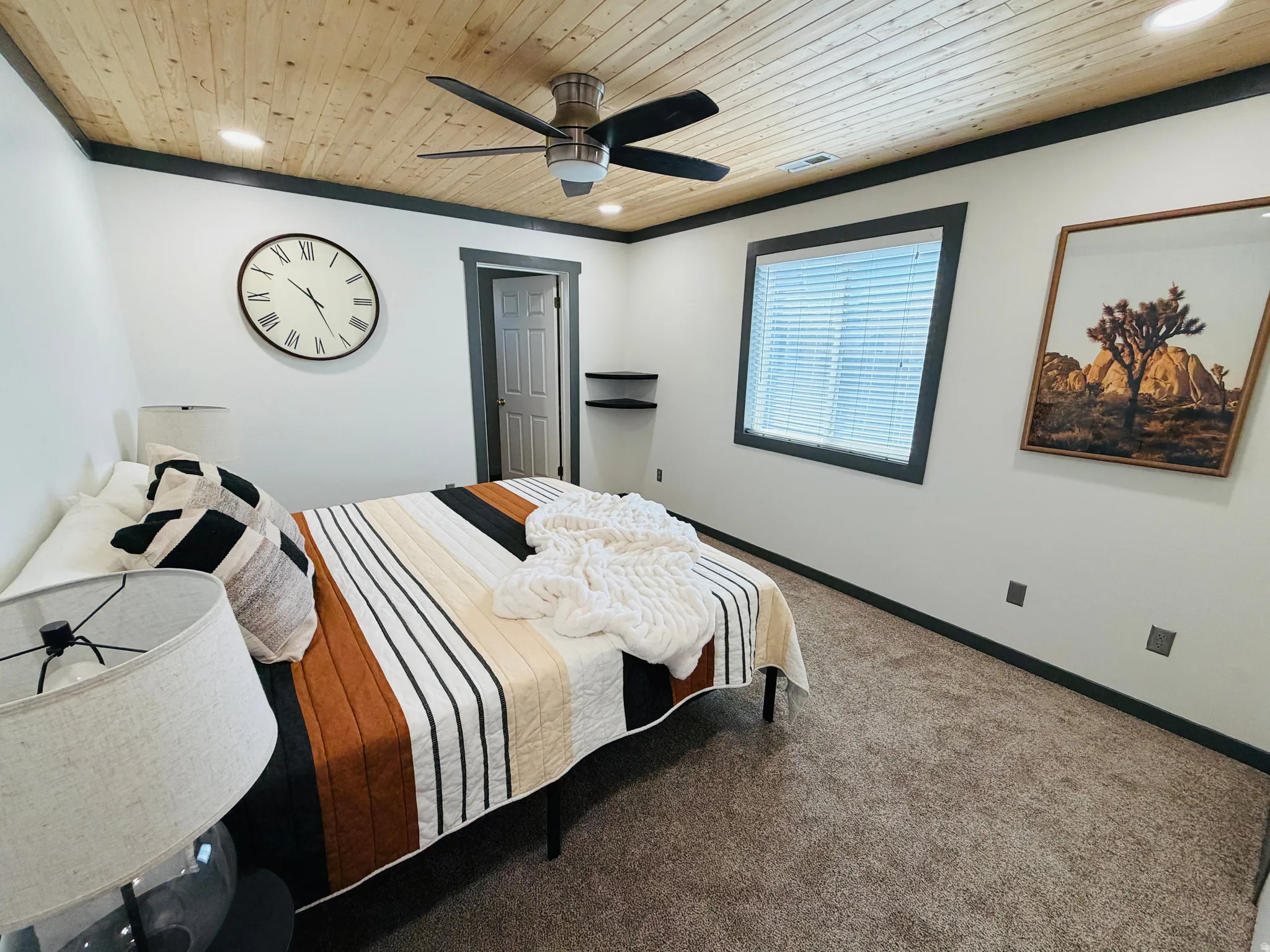 Room featuring a wood-panel ceiling with a ceiling fan, recessed lighting, and dark trim