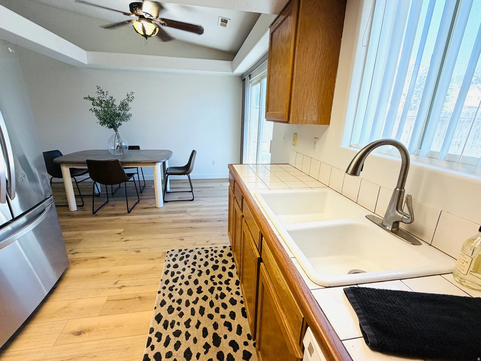 Kitchen sink with a white tile countertop and backsplash